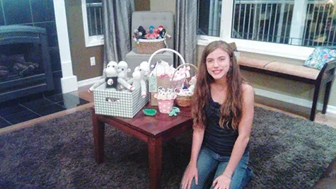 Briana Bloom, 14, poses with her sock puppet creations