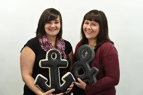 Bethany Speers and Melodie McMahon holding their handmade pillows