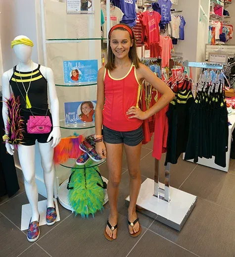 Maddie Thompson alongside her creations at Triple Flip in Winnipeg