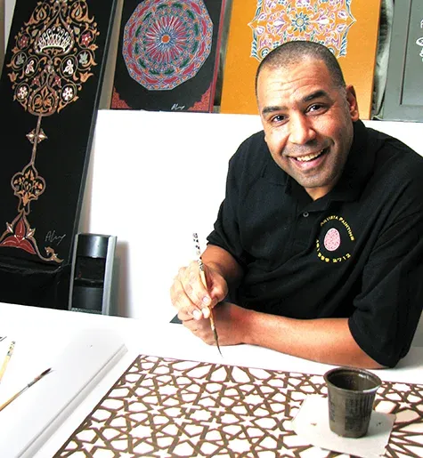 Ahmed Laarissa with some of his Moroccan paintings